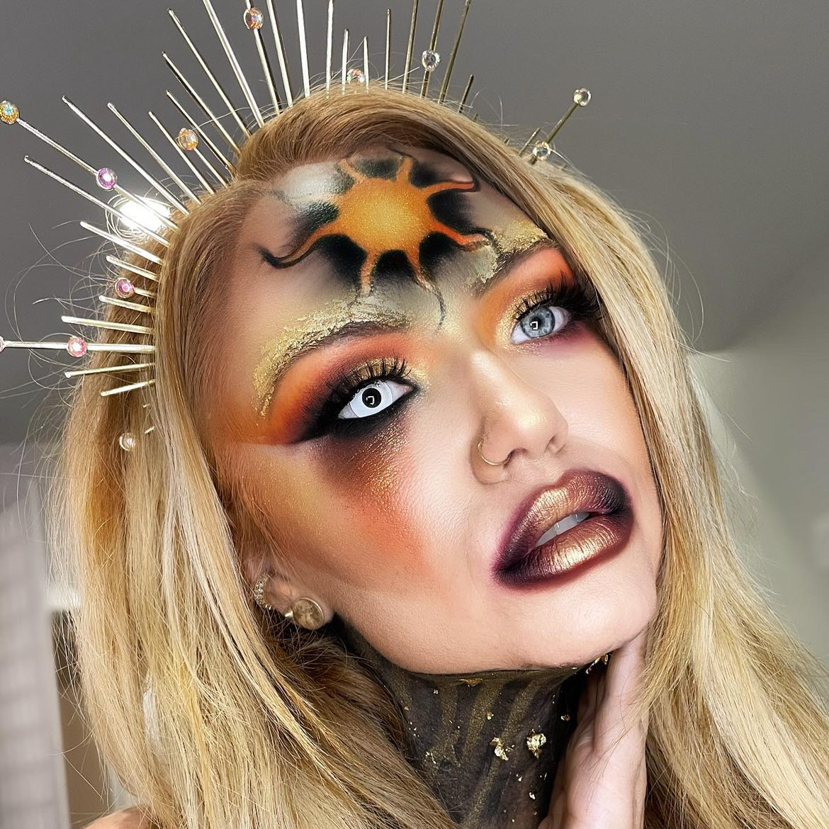 blonde girl with sun goddess halloween makeup 