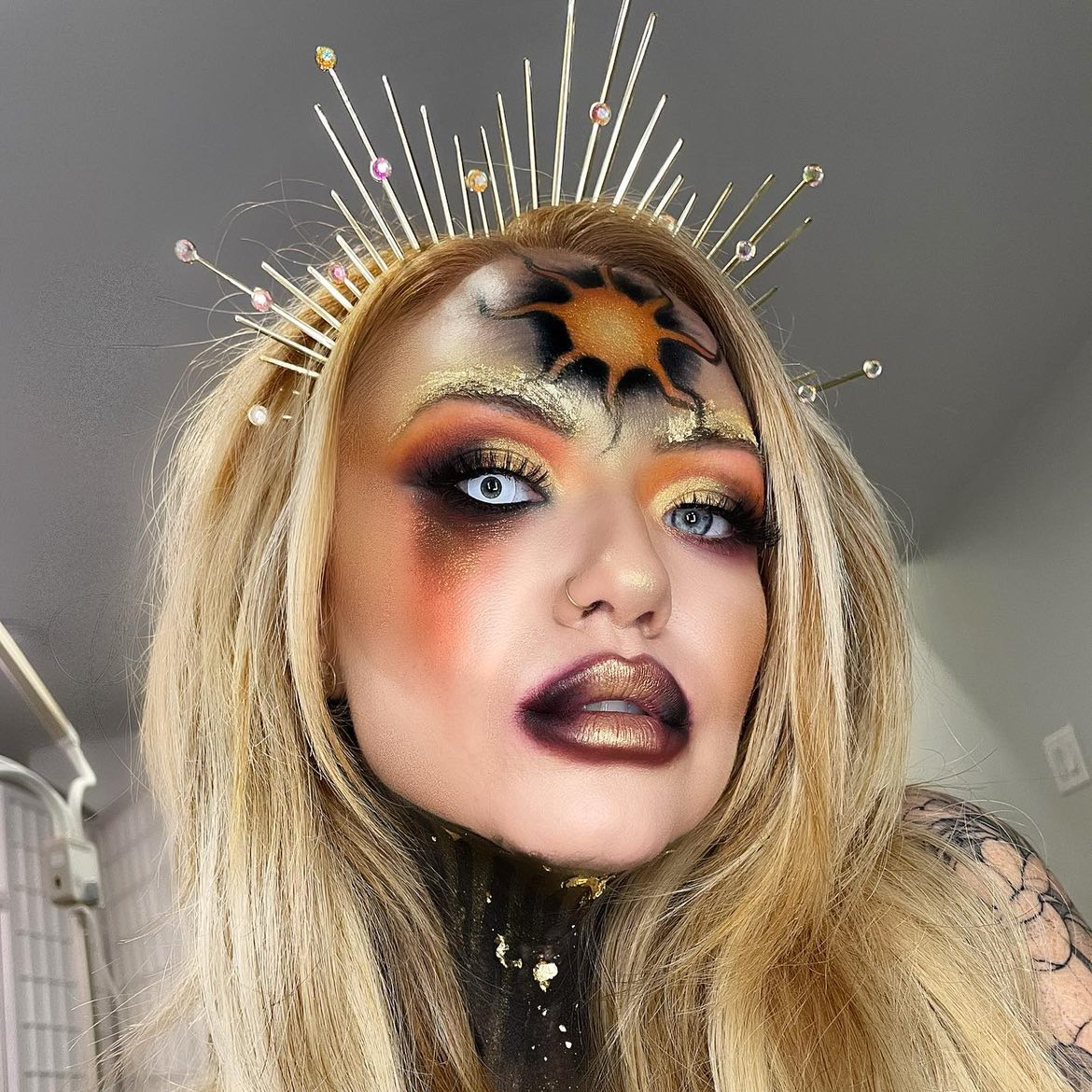 blonde girl with sun goddess halloween makeup