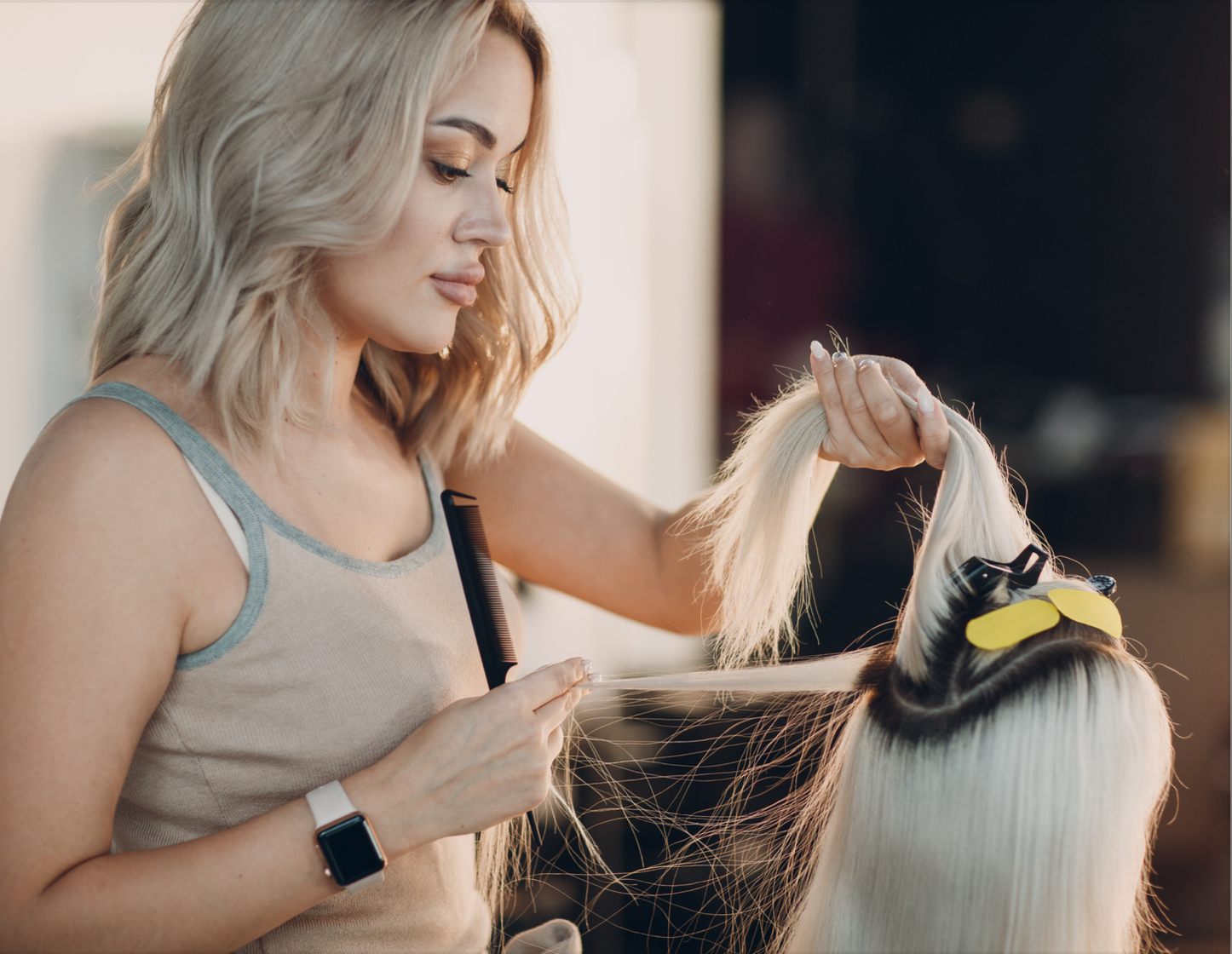 Hairdresser applying hair extension