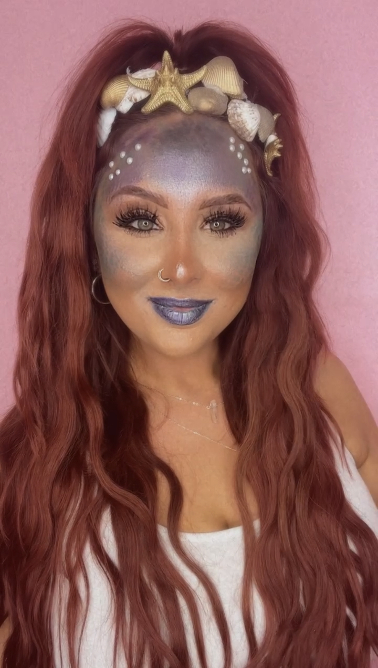 girl with red hair in mermaid costume with mermaid makeup