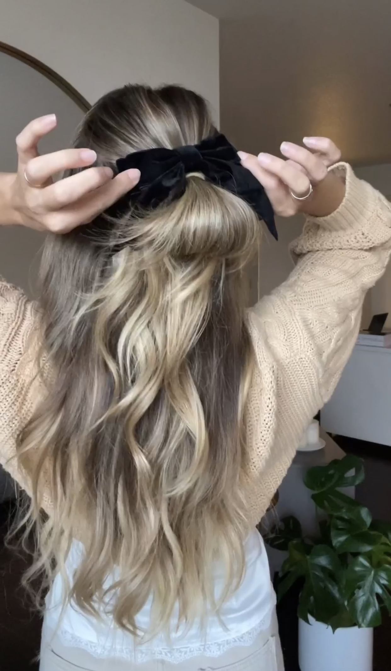 girl with half up half down bun with a bow