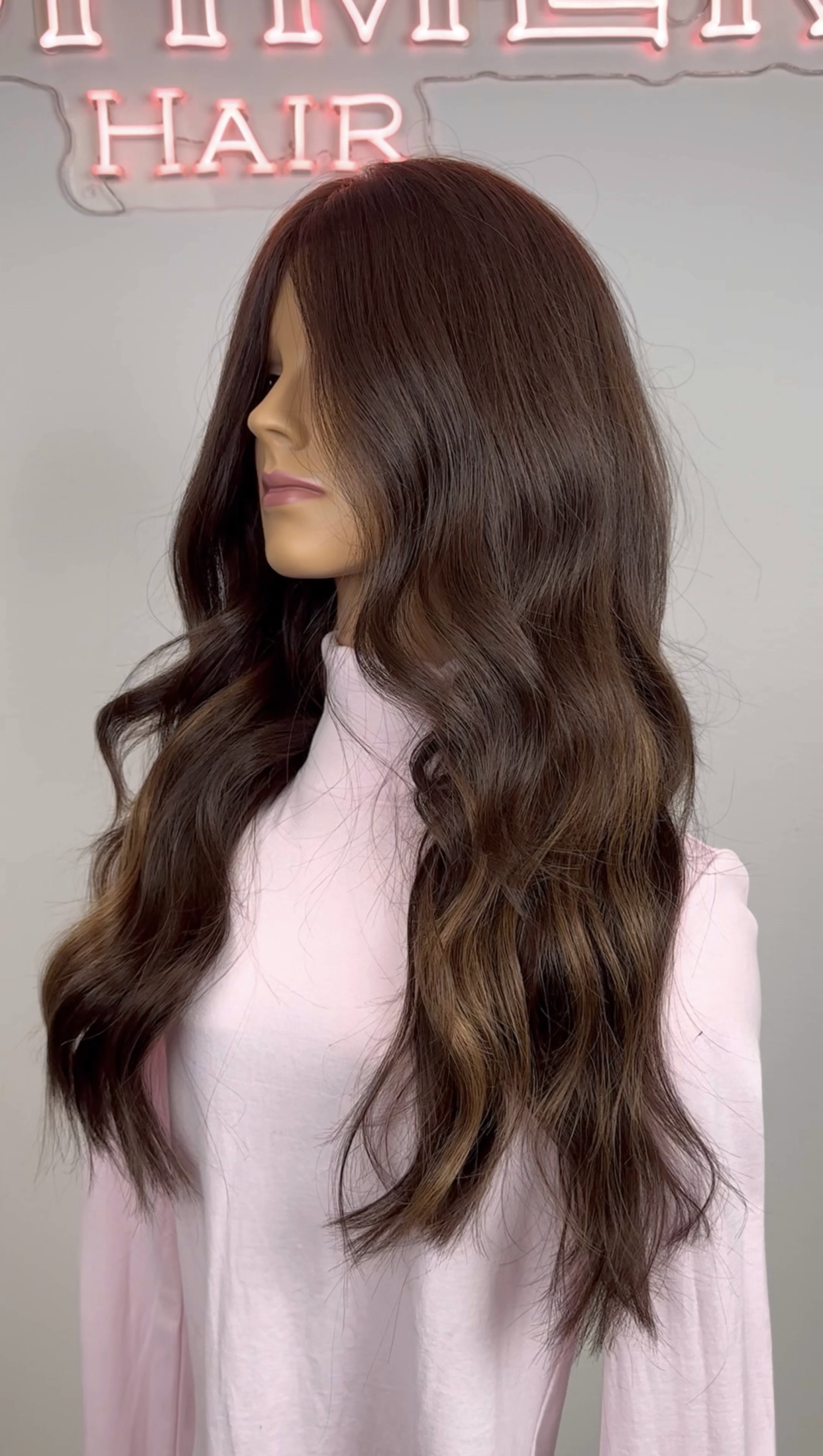 dollhead wearing a lighter shade of fill-in extensions to add highlights