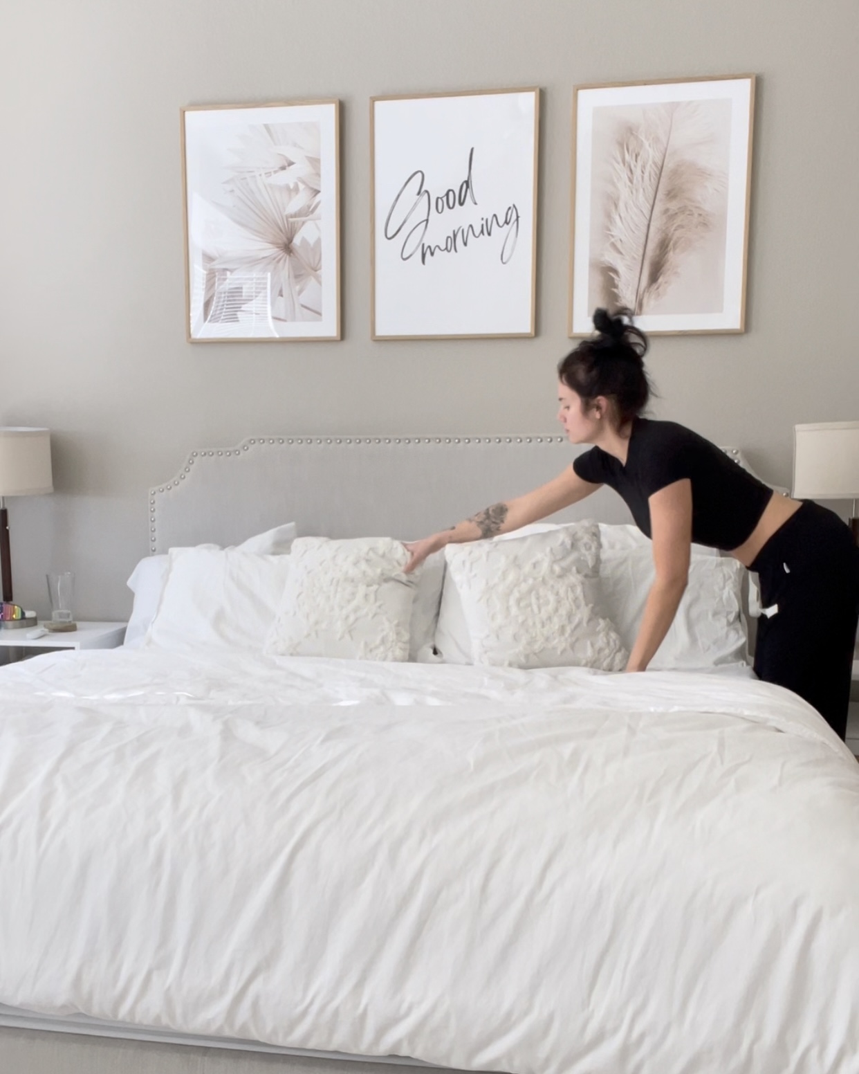 Woman waking up early and making her bed