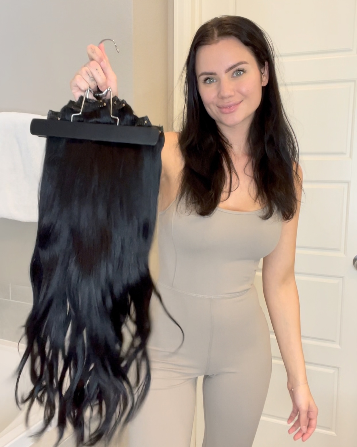 woman with cashmere hair extensions on the extensions hanger