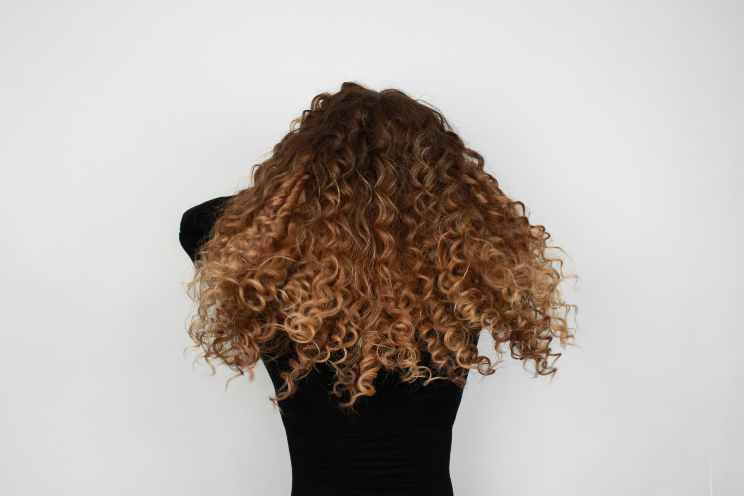 after photo of curly hair with extensions in from the back