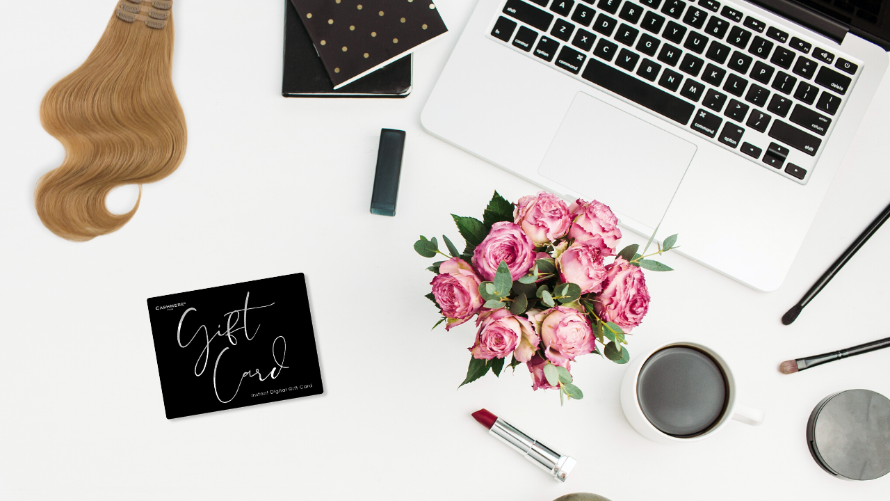 laptop flatlay with cashmere hair fill-in extensions and a cashmere hair gift card