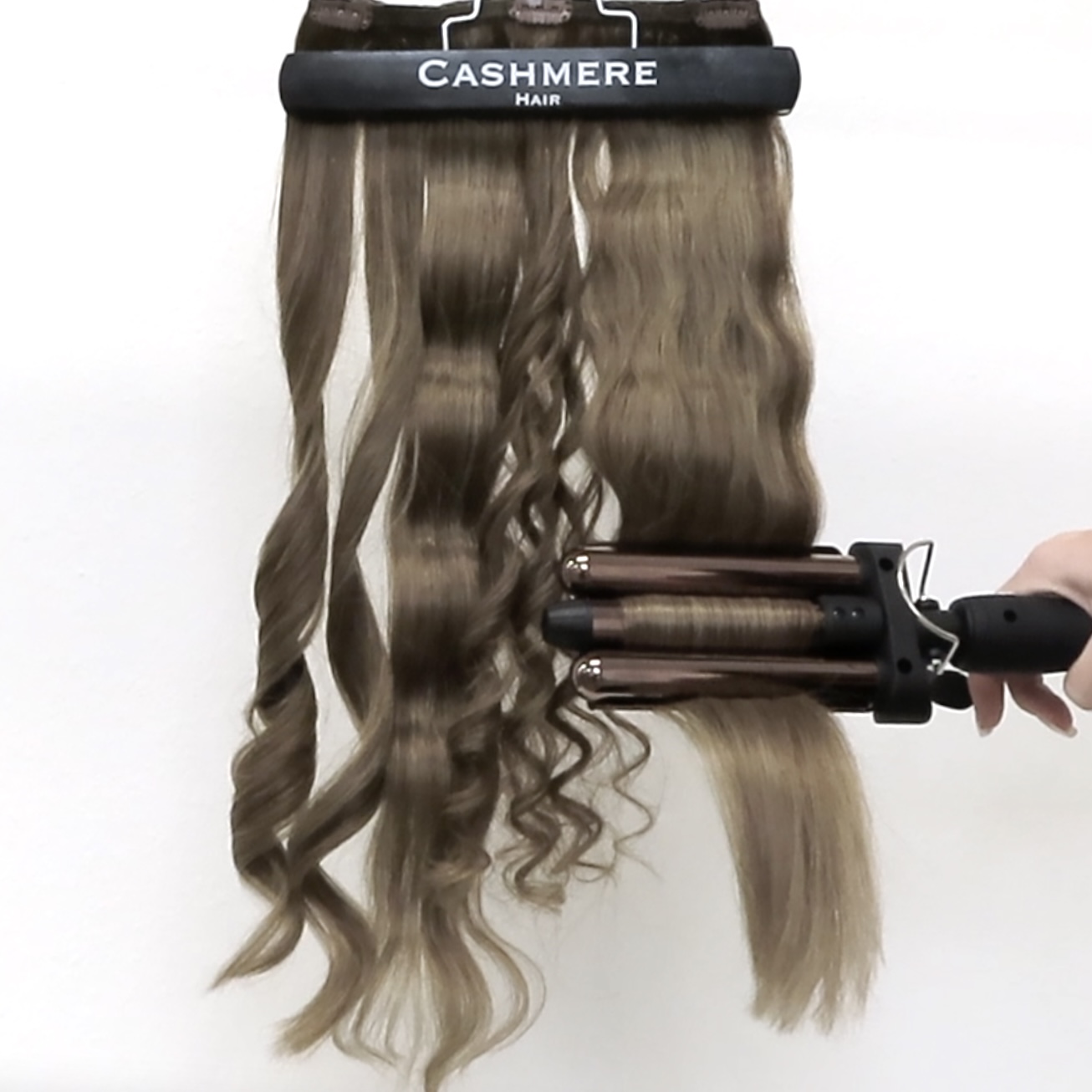 clamping 3 barrel waver crimper onto cashmere hair extensions
